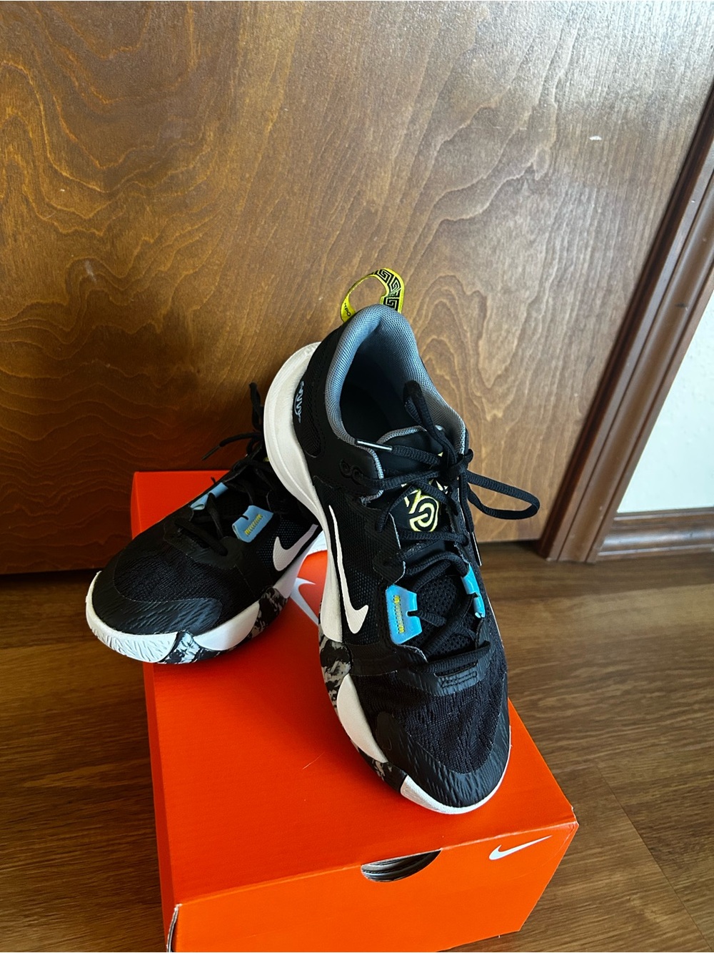 Nike Kids Black Sneakers with White Soles and Blue & Yellow Accents